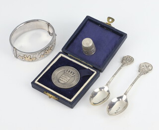 A commemorative silver medallion Birmingham 1947, 2 spoons, a thimble and bracelet 87 grams 