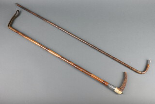 A silver mounted walking crop with horn handle together with a silver mounted bamboo effect walking cane 