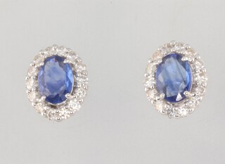 A pair of white metal 18ct oval sapphire and diamond ear studs sapphires 1.52ct diamonds 0.6ct 10mm x 7mm 3.8grams