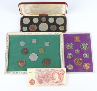 A cased 1953 Coronation coin set, 2 sets of mounted coins and a ten shilling bank note 