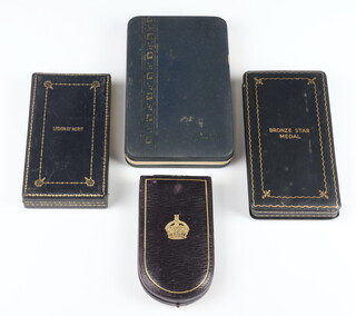 A Military Cross box, a Legion of Merit Box, a bronze star medal box and a USA medal box 