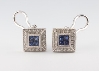 A pair of white metal 750 square sapphire and diamond ear studs (for pierced ears) comprising 8 princess cut sapphires surrounded by brilliant cut diamonds 5.4 grams, 10mm  