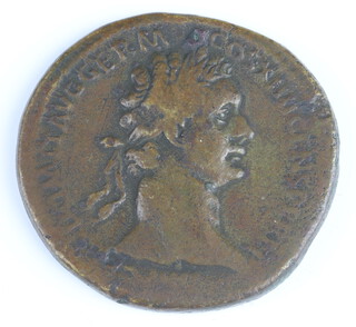 A brass sestertius coin for Domitianus 81-96AD, the reverse side shows Domitianus (left) holding a spear with winged Victory (right) holding a palm frond 