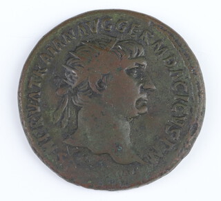 A bronze dupondius coin for Trojan Rome 101AD, the reverse side shows Justitia seated on a chair formed by 2 crossed cornucopiae 