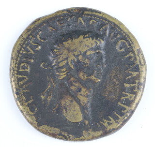 A brass sestertius coin for Claudius, Rome 41/2AD, the reverse shows an oak-wreath containing four lines of text 