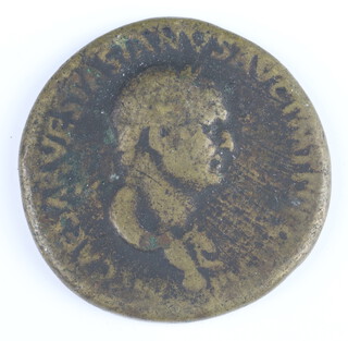 A Roman brass sestertius coin for Vespasian, 69-69AD, the reverse shows Liberty standing, holding a piles and a sceptre 