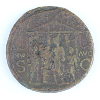 A Roman brass sestertius coin for Caligula, 40-41AD, one side shows Pietas seated with her elbow resting on a statuette, the other side shows Caligula (left) offering a sacrifice at the altar of Divus Augustus 