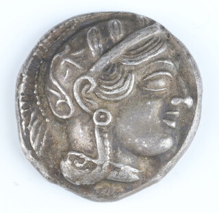 A silver tetradrachm coin of Attica, minted at Athens 450-400 BC, Athena on one side, owl on the other side 