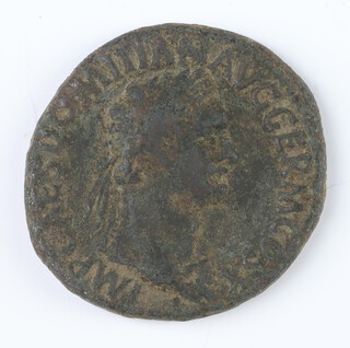 A brass dupondius coin of Domitian, the reverse shows the facade of an altar enclosure with double panelled doors 