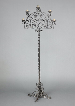 A blacksmith made wrought iron arch shaped 5 light standard lamp, raised on spiral turned column, cruciform base 180cm h x 72cm 