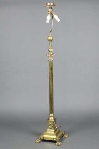 A 19th Century brass adjustable oil lamp raised on a Corinthian column capital with reeded column, square stepped base and paw feet, converted to electricity 66cm h x 35cm x 35cm 