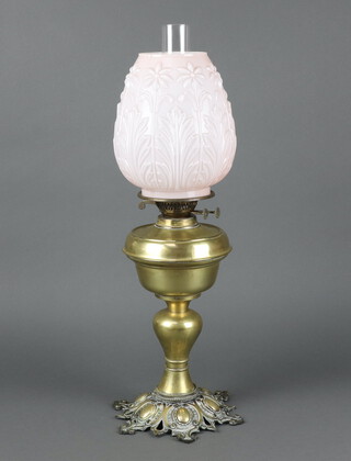 A gilt metal oil lamp reservoir with opaque glass shade and chimney and embossed brass base 62cm h x 16cm 