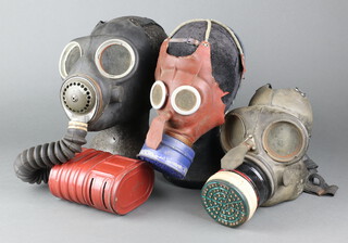 A child's  Second World War Mickey Mouse gas mask (some perishing to the rubber), a WWII Civil Defence gas mask and a ditto service respirator 