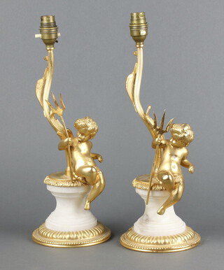 Two gilt metal marble effect table lamps supported by cherubs on circular bases 38cm h 