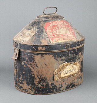 A 19th Century oval pressed metal military hat box with hinged lid 42cm x 47cm x 32cm (some labels and dents) containing a Victoria J jockey's cap size 7 