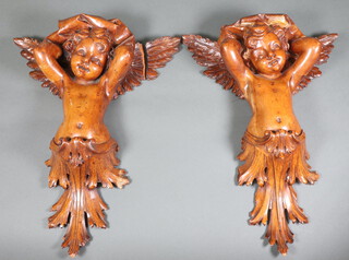 A pair of 19th Century carved lime wood wall brackets in the form of cherubs 42cm x 30cm 