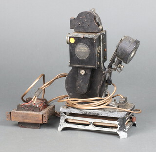 A Pathe Baby 1922 9.5mm projector, converted to a battery (corroded) 