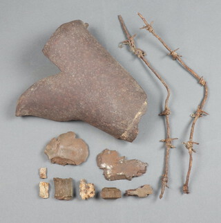 A large section of shrapnel 24cm x 19cm, small collection of shrapnel and 2 small sections of barbed wire 