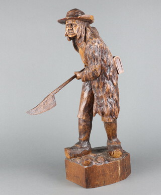 A carved wooden figure of a standing "Pikeman" with pike 53cm h x 20cm w x 12cm d 