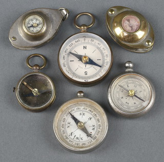 A collection of 6 miniature compasses 
