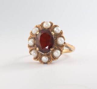 A yellow metal 9ct oval garnet and pearl ring size M, 4.4 grams 