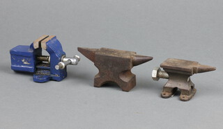 Two miniature anvils 5cm x 10cm x 3cm and 4cm x 6cm x 3cm and a miniature vice 5cm x 8cm x 5cm 