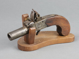 Coee of Devizes, a 19th Century  box lock flintlock pocket pistol with 4cm screw off barrel and walnut grip