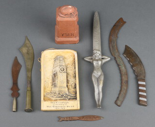 A plaster ornament in the form of a Belgian war memorial 12cm x 6cm x 5cm and 6 trench art paperknives 