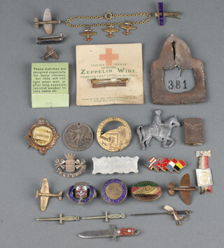 A First World War Red Cross brooch formed from Zeppelin wire, bought down at Cuffley Essex, together with various WWI lapel badges etc 