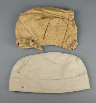 James Forsyth, a Second World War cloth flying helmet with original paper label marked 1940, size  6 7/8, (some staining to the fabric) together with an American field service cap 