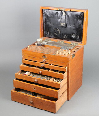 The Dental Manufacturing Company Ltd, a dental chest with hinged lid fitted 6 short drawers containing various drills and instruments 33cm x 32cm x 23cm 