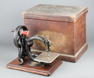 Wilcox and Gibbs, a manual sewing machine, complete with wooden carrying case  