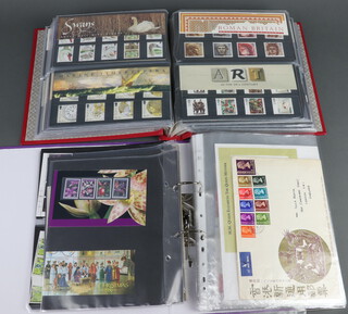 An album of 100 GB presentation stamps 1987 - 1998 together with a purple ring bound album of mint GB and World stamps 1960-1970 including Belgium, Germany, Kenya, Australia and first day covers of Spain, Hong Kong 