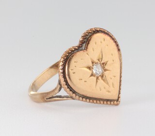 An Edwardian yellow metal heart shaped diamond set ring, the diamond 0.05ct, size K, 2.6 grams 