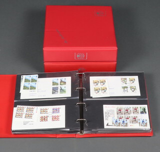 A collection of 355 GB Elizabeth II first day covers comprising 2 1960, 12 1970, 89 1980-1989, 100 1977-1988, 56 Christmas first day covers 1956-1996 with additional mint stamps, 96 1970-1980 first day covers with additional stamps, in green Stuart albums  