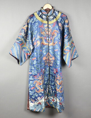 A Chinese late Qing dynasty blue silk formal court robe ( Chi-fu or Dragon robe ), embroidered 8 five clawed dragons with flaming pearls, bats, clouds, auspicious symbols with a cut down Lushi hem the (remnants of which appear to to have be added to the sleeves), the dark burgundy lining partly decorated a colourful dragon. 