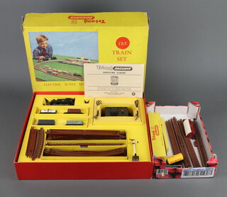 A Triang Railways electric scale model TBX train set TT gauge, boxed with original insert card, servicing scheme, manual and cardboard protector together with a small collection of track, box of points and a boxed Bogie wagon 