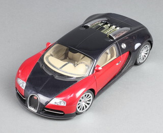 An Autoart 1:18 scale model of a Bugatti EB 16.4 Veyron showcar, in black and red, numbered 7645, boxed 