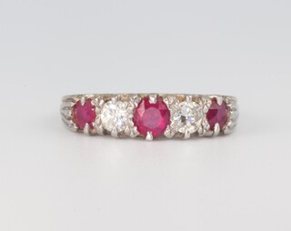 A white metal 3 stone ruby and 2 stone diamond ring, rubies approx. 0.50ct, the diamonds approx. 0.40ct, size M 1/2, 3.4 grams 