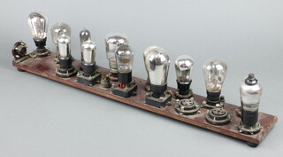 A valve display board with valve sockets and early valves for display only including Marconi DER, Mullard DFA4, Mullard LF, some with BBC logo