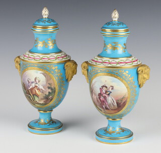 A pair of 19th Century Sevres turquoise ground vases and covers with mask handles and panels of dancing figures and flowers with gilt decoration 25cm 