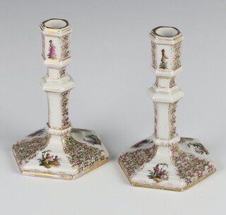 A pair of 19th Century German hexagonal candlesticks decorated with panels of figures and flowers 13.5cm 