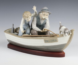 A Lladro group "Fishing With Gramps" in a boat named Paloma 38cm, complete with wooden stand 
