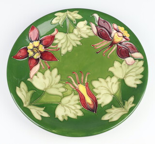 A Walter Moorcroft green ground charger decorated the fuschia pattern 26cm 