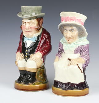 A pair of Sarreguemines character jugs of a seated lady and gentleman 3430 and 3329, 30cm 