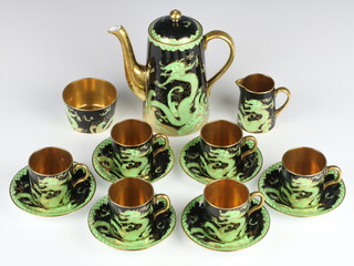 A New Chelsea Staffordshire Art Deco coffee set, the black ground with green and gilt dragon decoration comprising coffee pot, 6 coffee cans, 6 saucers, milk jug, sugar bowl 