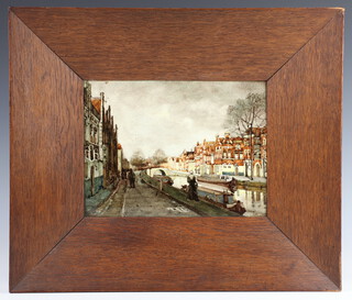 A Dutch Rozenburg Den Haag ceramic tile, after a work by Klinkenberg painted a canal scene with figures and buildings the reverse marked Rozenburg Den Haag  in an oak frame 17cm x 23cm 