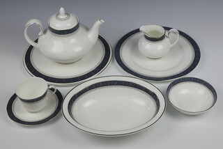 A Royal Doulton Sherbrooke tea and dinner service H5009 comprising 12 tea cups (7 seconds), 17 saucers (10 seconds), tea pot, milk jug (both seconds), 7 dessert bowls (5 seconds), 2 sauce boats (1 second), 1 stand, serving plate, cake stand, 11 small plates (10 seconds), 8 side plates, 14 dinner plates (8 seconds) and a vegetable dish (second) 
