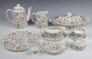 An extensive Haddon Hall tea, coffee and dinner service comprising 6 large mugs (5 seconds), 6 tea cups (1 second), 6 saucers (1 second, 1 a/f), 6 soup cups and 6 saucers, tea pot, breakfast tea pot, sugar bowl and lid, milk jug, preserve pot and lid, 6 large dessert bowls, 6 small dessert bowls, 6 egg cups, 9 side plates (3 seconds), 6 soup bowls, 6 small plates, 10 medium plates, large vegetable tureen and cover, sauce boat and stand, 6 coffee cups, 6 saucers, bread knife, cake slice, 6 small coffee mugs, 6 saucers, coffee pot, 2 large serving plates (both seconds), cream jug, milk jug, cake stand, salt, pepper and mustard, 6 napkin rings, 3 oval vegetable dishes, 6 hors d'oeuvres dishes (all seconds), 6 large dinner plates, 6 small dinner plates, cake plate, meat plate, place mats and glass mats 