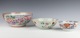 An 18th Century famille rose export bowl decorated with figures at pursuits, with panels of birds 26cm (cracked, stuck and chipped), a 19th Century Imari bowl decorated with flowers 13cm (cracked and chipped), together with a famille rose bowl decorated with flowers and peaches 20cm (cracked)